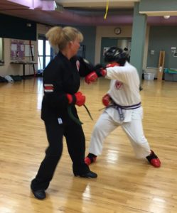 Two people participating in a martial arts class.