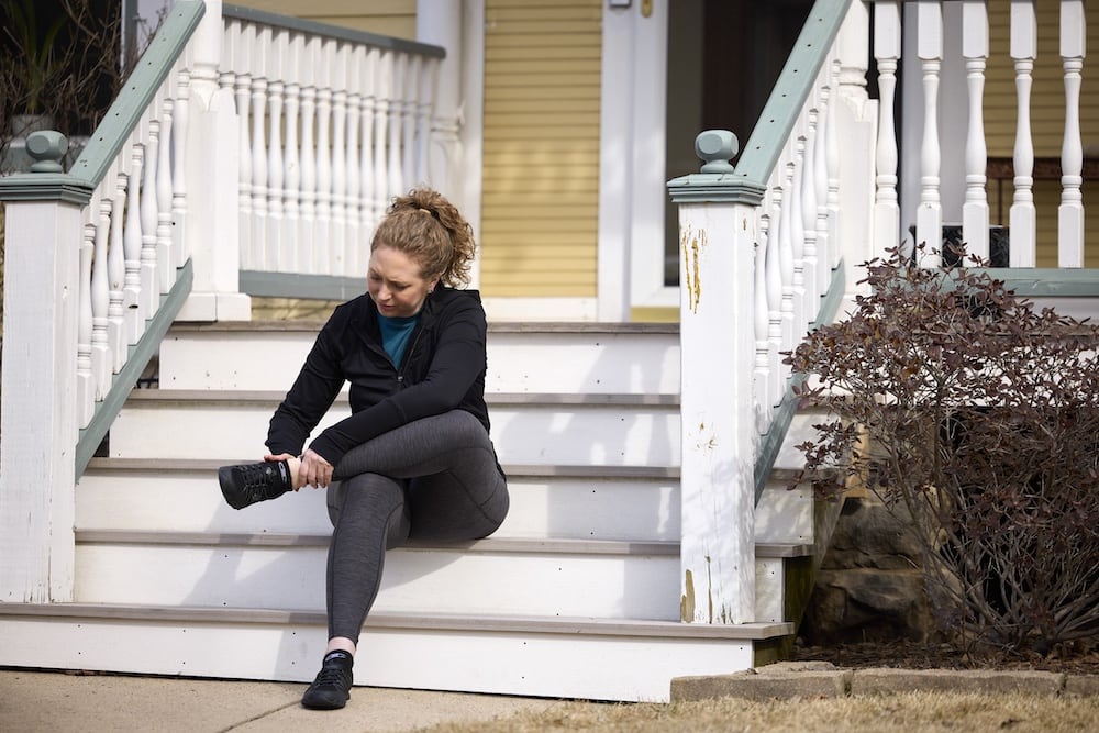 woman sitting on porch with ankle pain