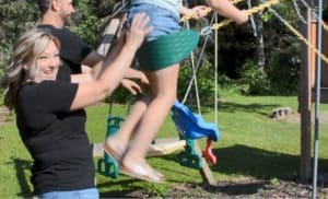 Heidi pushing child on a swing