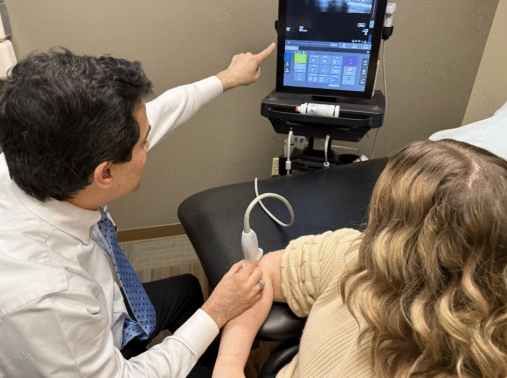 Garcia with patient doing an ultrasound of elbow to diagnose condition